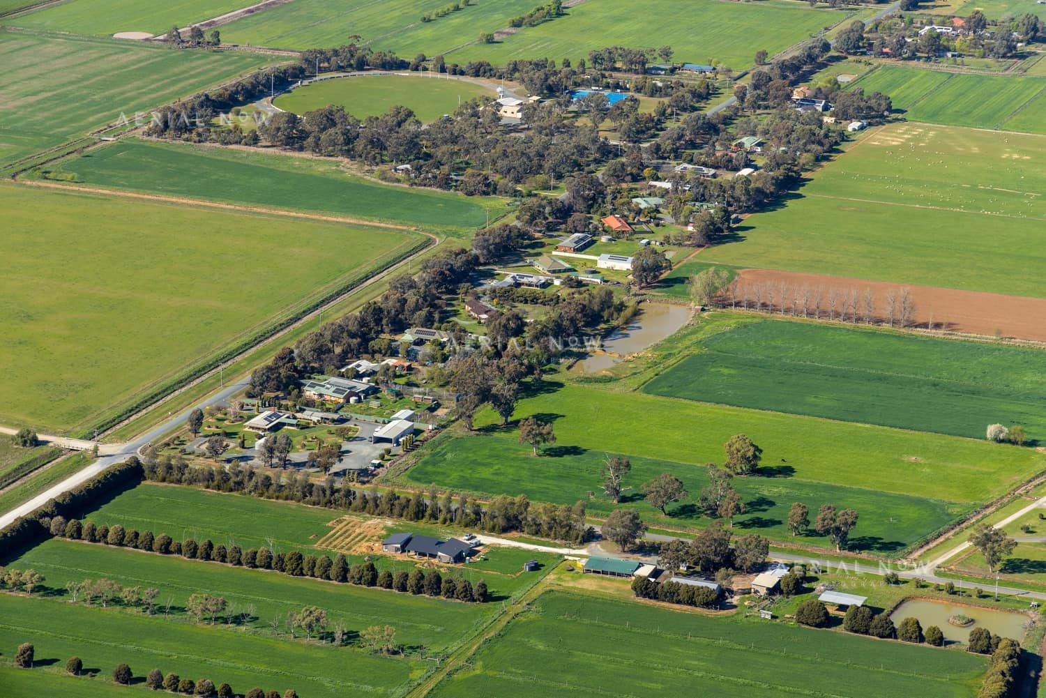 Aerial view of farmland and rural homes along Weller Road in Lancaster VIC, with green paddocks, tree lines and farm tracks.