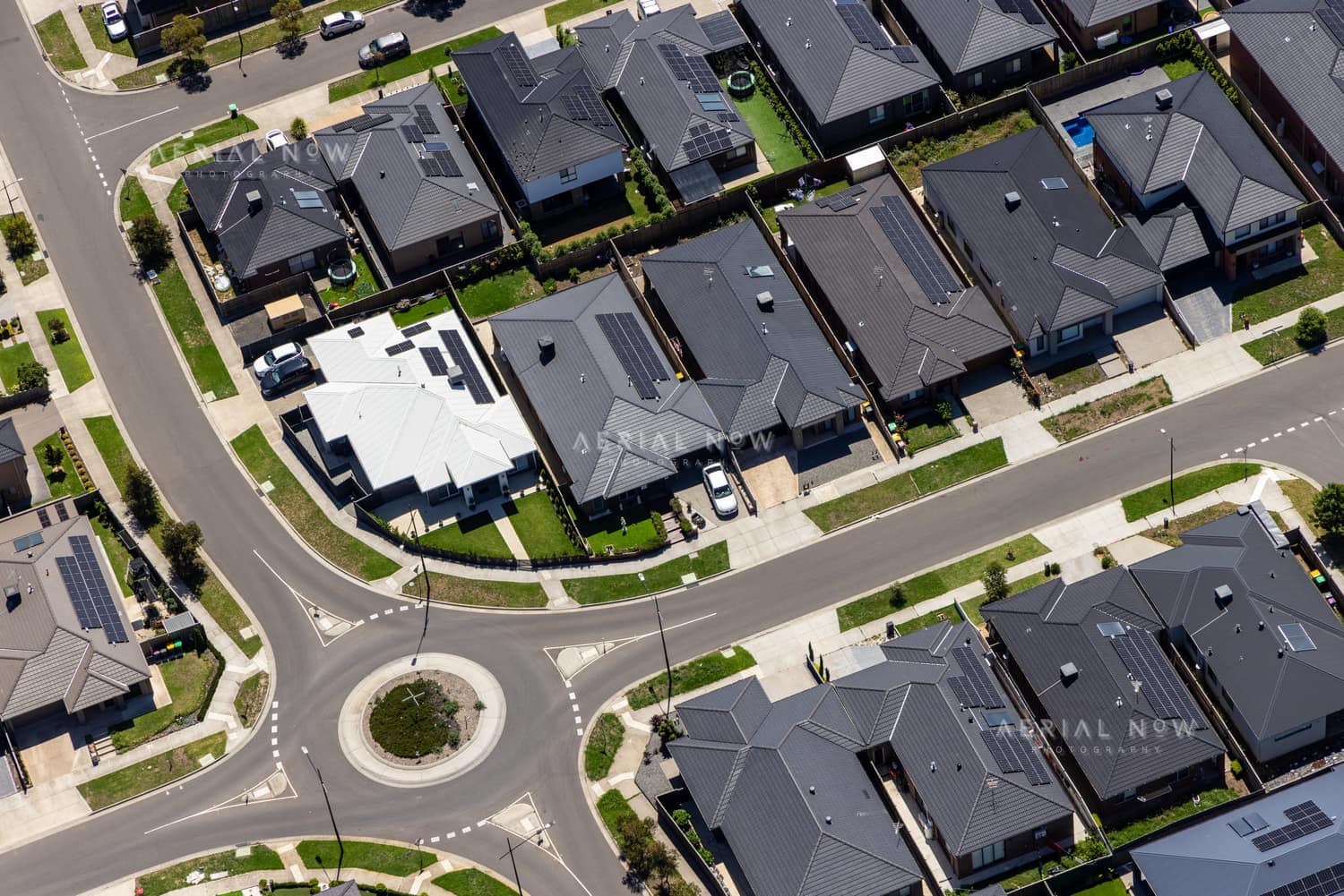 Aerial view of modern houses, driveways and a small roundabout in the Bethnal Avenue residential estate in Wollert, Victoria.