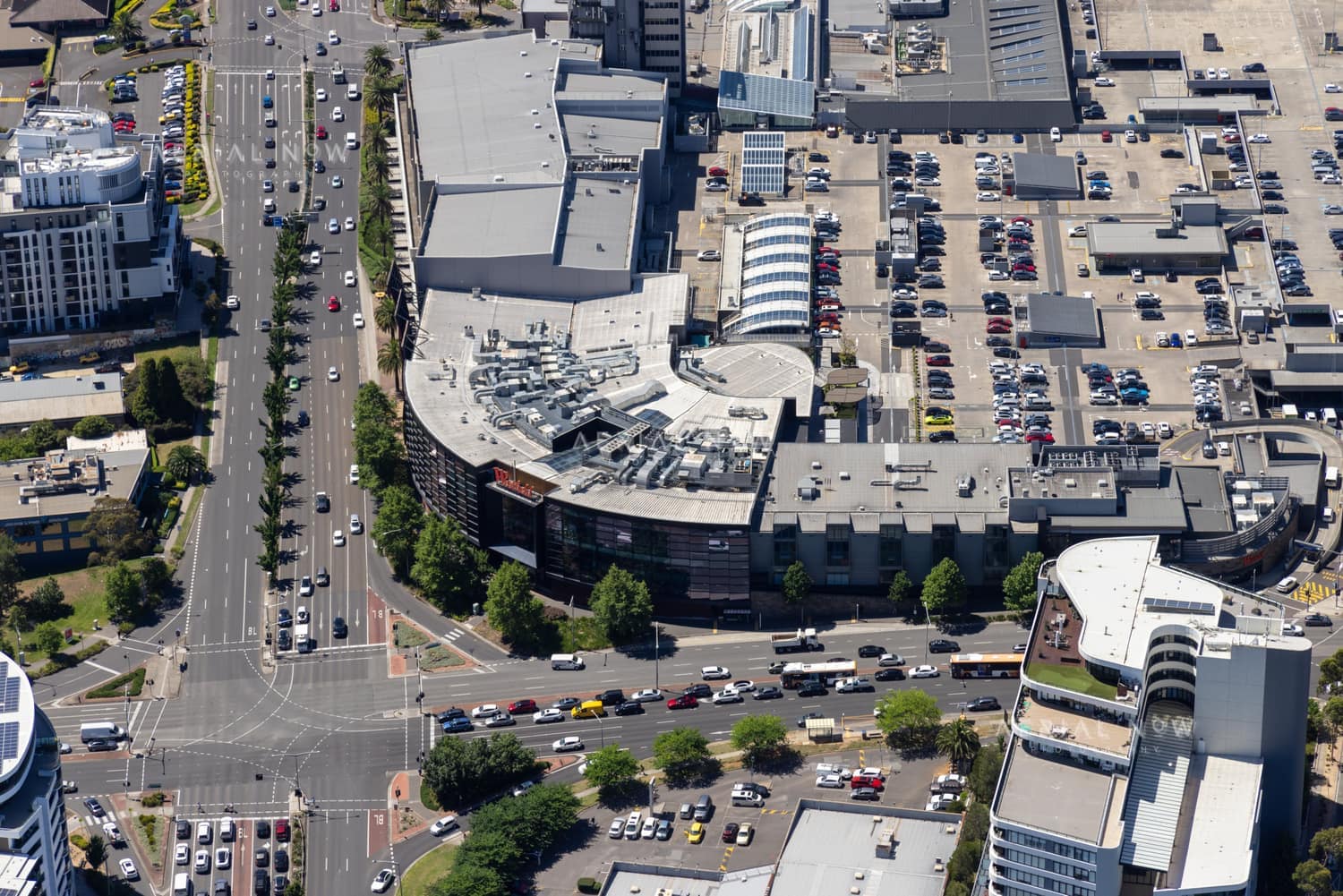 Aerial view of Westfield Doncaster in Doncaster VIC, showing rooftop parking, surrounding commercial buildings, Doncaster Road traffic and nearby intersections.