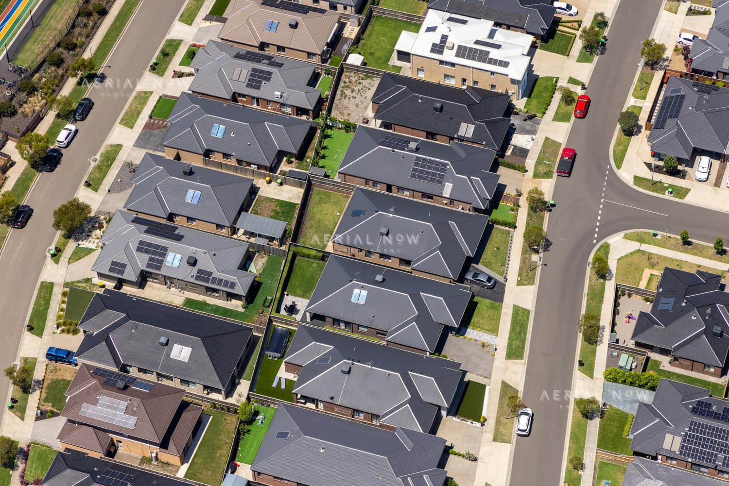 Aerial view of modern residential homes, streets and backyards around Light Horse Circuit in Sunbury, Victoria.