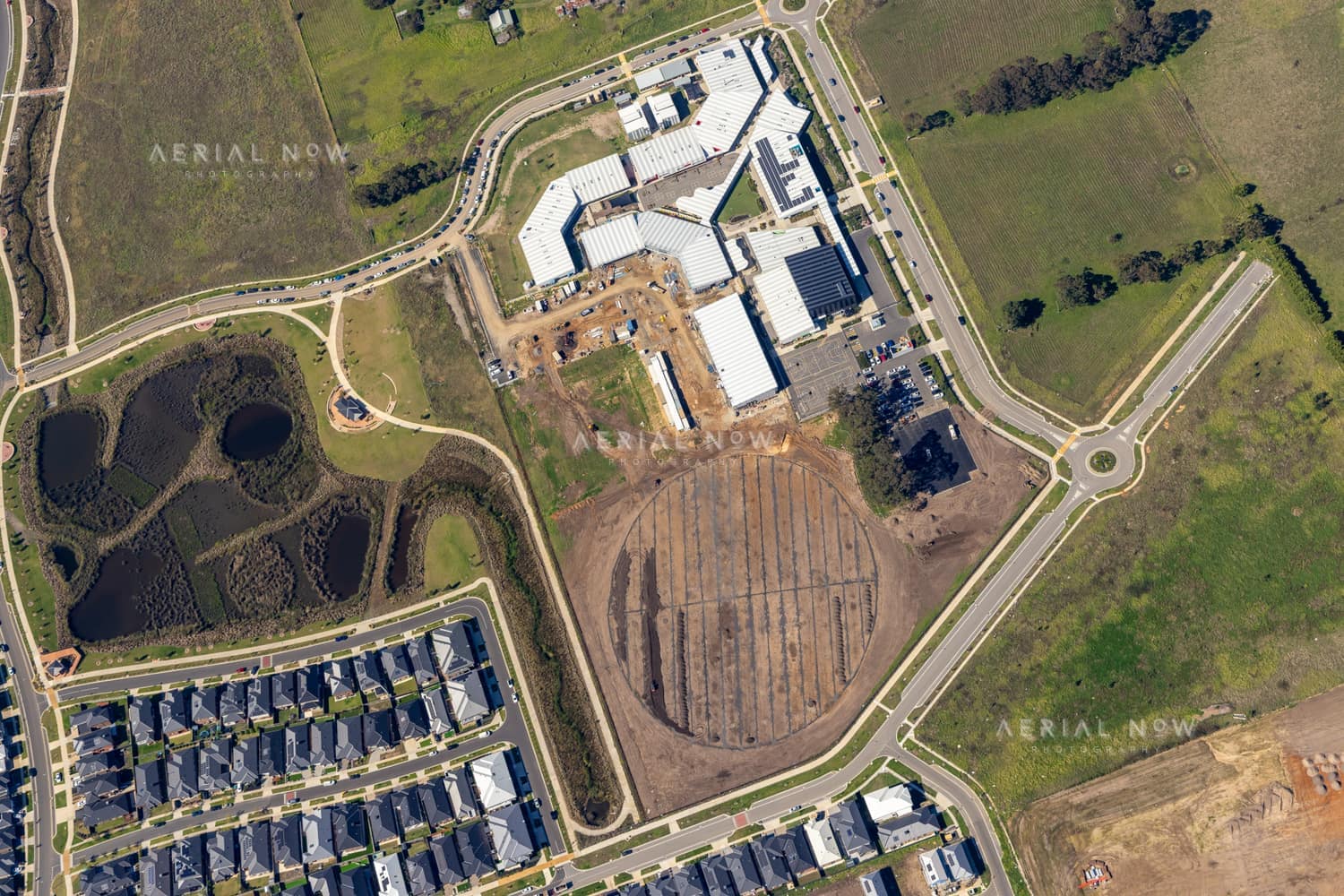 Aerial view of Clyde Secondary College with Stage 2 expansion works, hardcourts and the prepared sports-oval area in Clyde, Victoria.