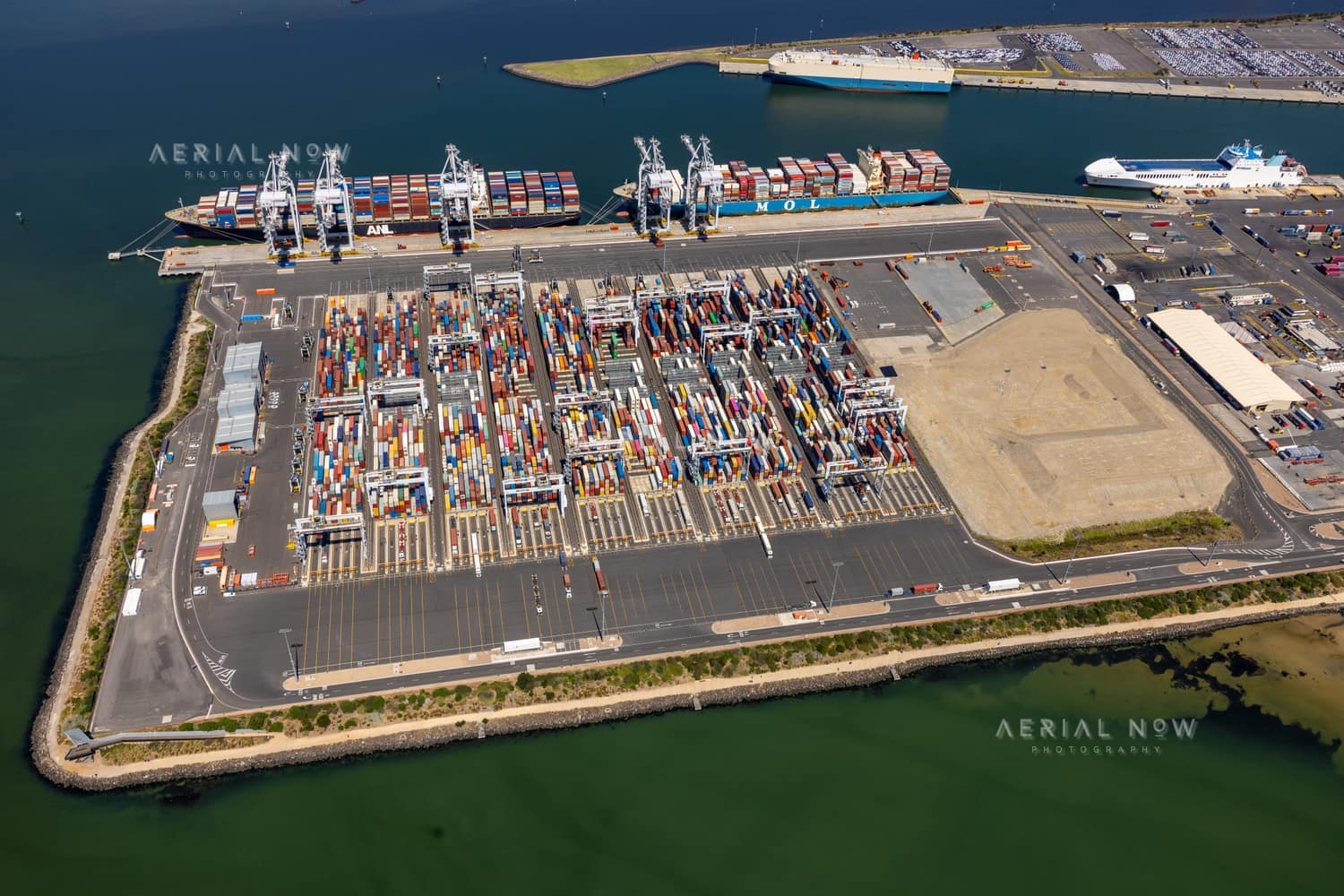 Aerial view of container ships, ship-to-shore cranes and container stacks at Webb Dock East, Port Melbourne, in February 2022.