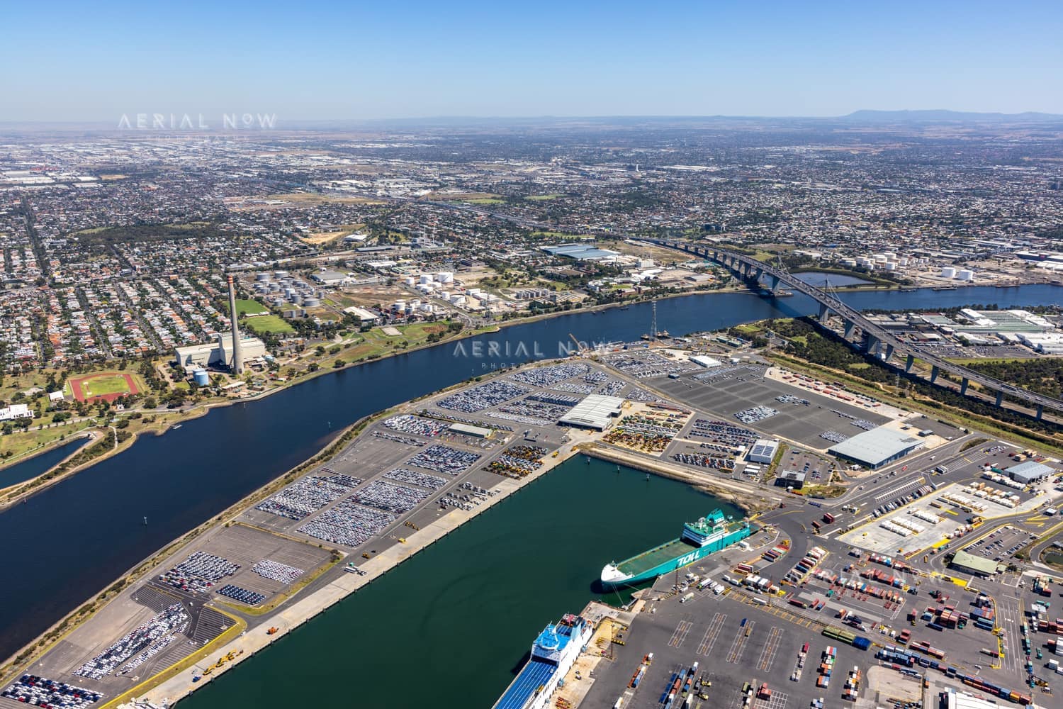 Aerial view of Webb Dock West vehicle-storage areas, roll-on roll-off berths, the Yarra River and West Gate Bridge at Port Melbourne in February 2022.