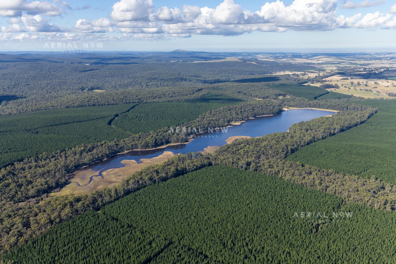 Aerial view of Bostock Reservoir surrounded by forest, plantation land and rural roads near Barkstead and Bolwarrah, Victoria.