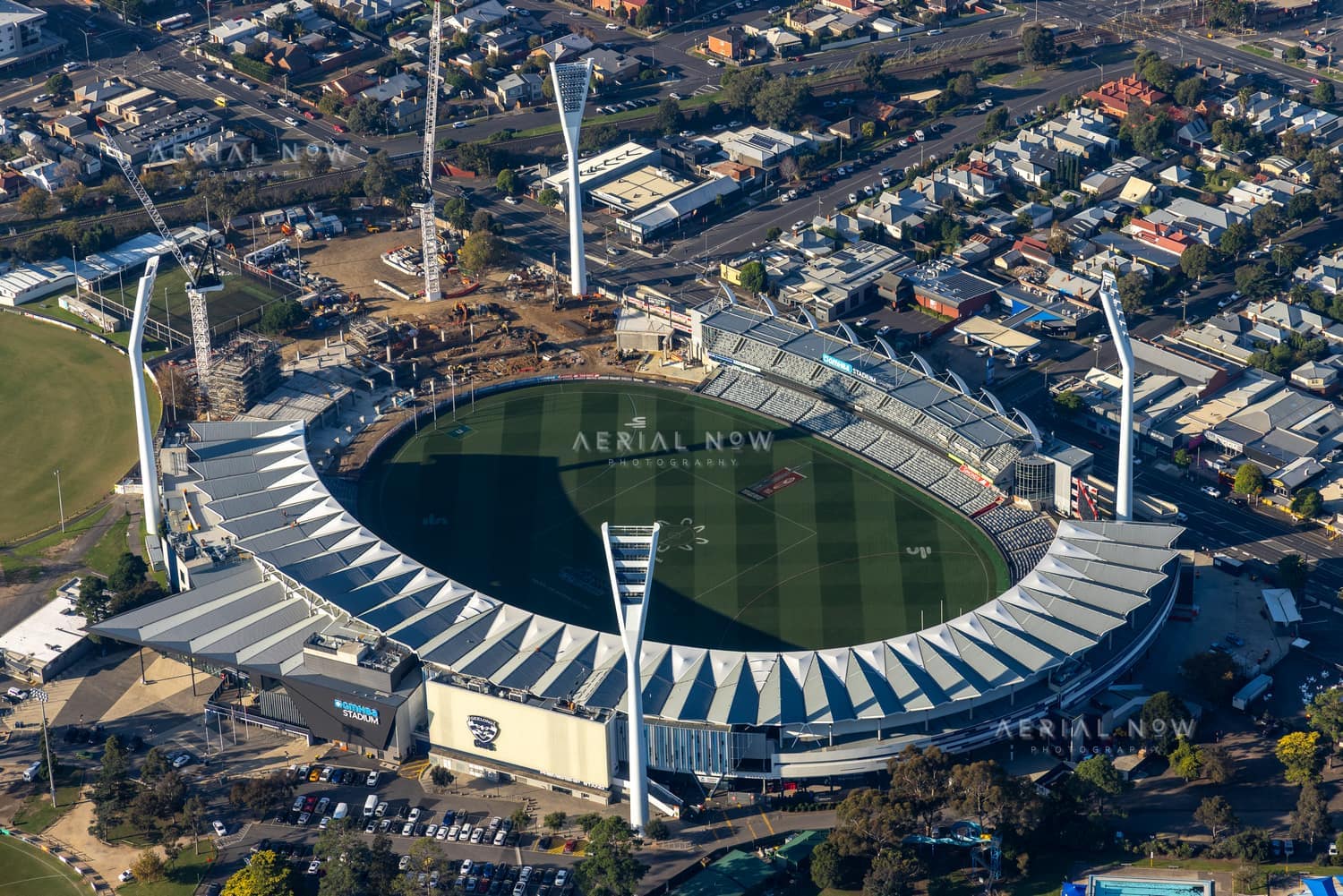 Aerial view of GMHBA Stadium at Kardinia Park in South Geelong VIC, showing the oval, grandstands, light towers, surrounding streets and nearby construction works.