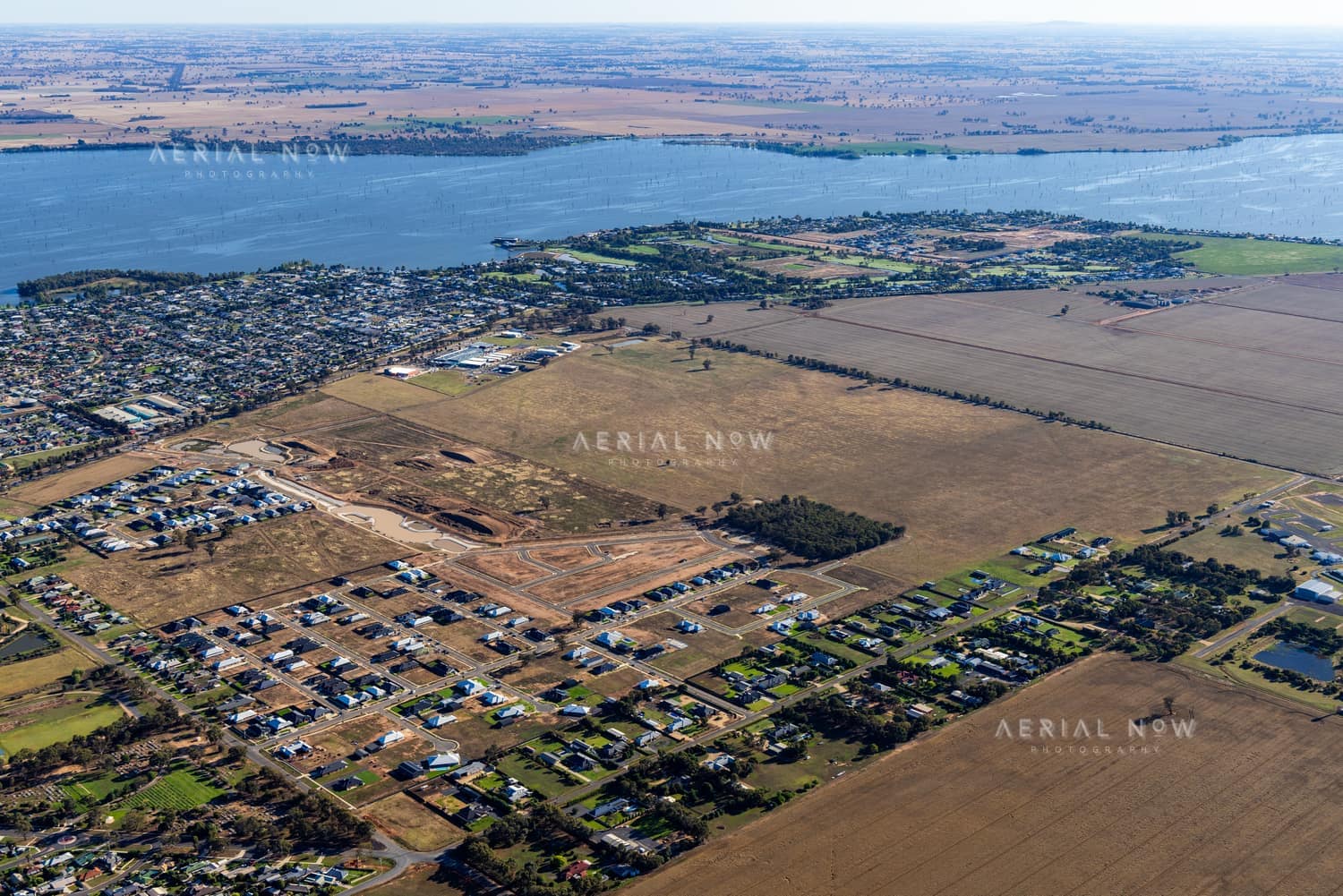 Aerial view of residential subdivision works and lakeside housing beside Lake Mulwala in Yarrawonga, Victoria.