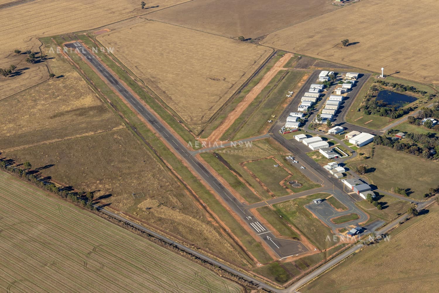 Aerial view of Yarrawonga Airport in Yarrawonga VIC, showing the runway, taxiways, hangars, apron areas and surrounding rural farmland.