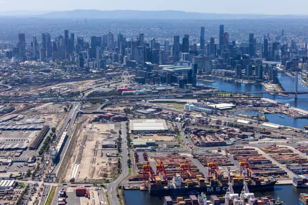 Aerial view of Port of Melbourne container terminals, the Port Rail Transformation Project construction site, Bolte Bridge and the Melbourne CBD skyline in February 2022.