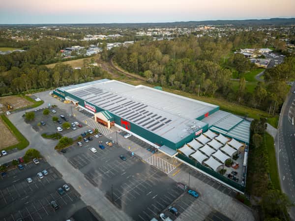 Aerial view of Bunnings Warehouse Taree on Wingham Road with car parking, surrounding trees and nearby commercial areas in Taree NSW.