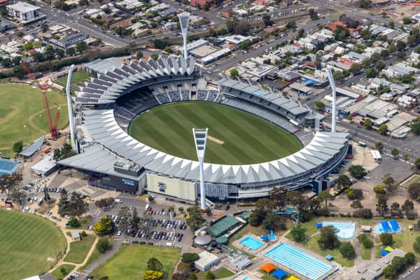 Aerial view of GMHBA Stadium at Kardinia Park in South Geelong, with the oval, grandstands, light towers, surrounding streets, car parks and nearby aquatic facilities visible.