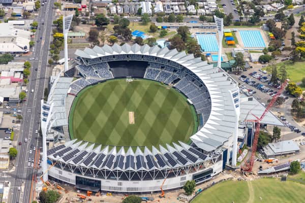 Aerial view of GMHBA Stadium at Kardinia Park in South Geelong, showing the oval, grandstands, light towers, nearby Moorabool Street, aquatic centre pools and construction activity.