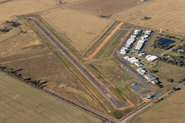 Aerial view of Yarrawonga Airport in Yarrawonga VIC, showing the runway, taxiways, hangars, apron areas and surrounding rural farmland.