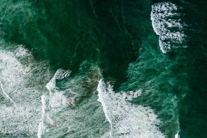 Aerial view of white surf patterns and deep green Southern Ocean water off Princetown, Victoria.