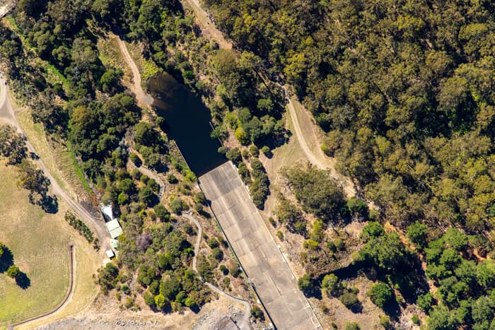 Aerial view of a West Barwon Reservoir inlet or offshoot surrounded by dense bushland and access tracks near Forrest, Victoria.