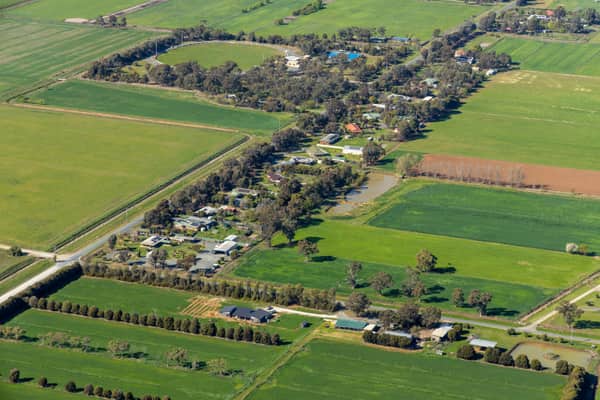 Aerial view of farmland and rural homes along Weller Road in Lancaster VIC, with green paddocks, tree lines and farm tracks.