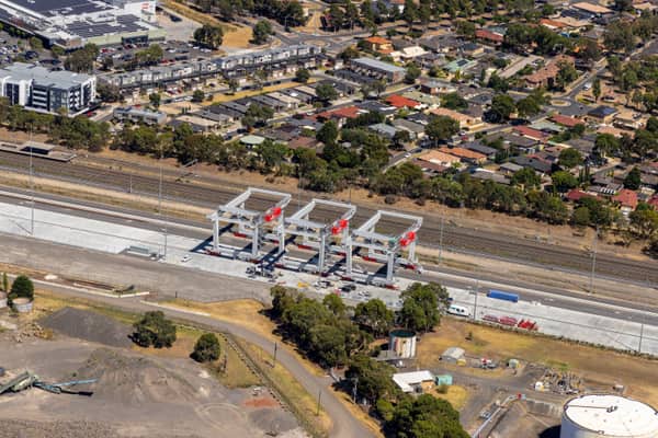 Aerial view of the Somerton rail freight terminal area with gantry cranes, rail sidings, freight handling infrastructure and nearby industrial land in Victoria.