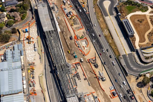 Aerial view of Eastern Freeway construction works in Balwyn North, with traffic, heavy machinery, work zones and nearby streets visible.