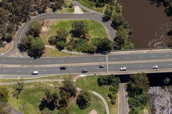 Aerial view of Fitzsimons Lane Bridge with the Yarra River in view and traffic passing over the bridge in Templestowe, Victoria.
