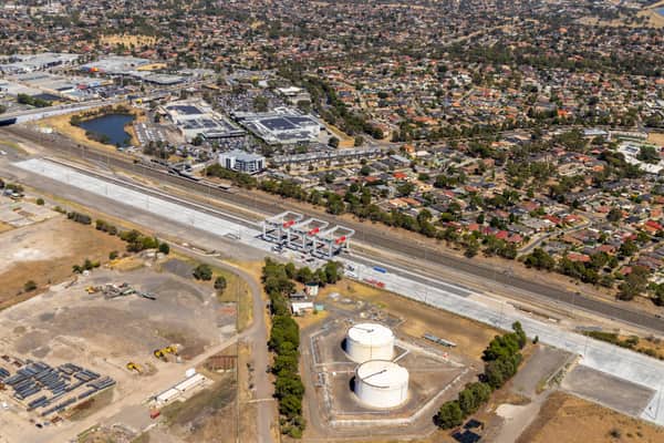 Aerial view of Union Road rail corridor construction in Somerton VIC, with concrete works, rail lines, nearby industrial tanks, commercial buildings and surrounding residential streets.