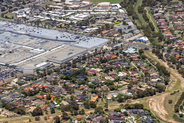 Aerial view of Pacific Werribee shopping centre beside Heaths Road, with large car parks, surrounding residential streets and parkland in Hoppers Crossing VIC.
