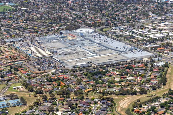 Aerial view of Pacific Werribee shopping centre in Hoppers Crossing, showing large retail buildings, car parks, surrounding suburban streets and residential neighbourhoods.